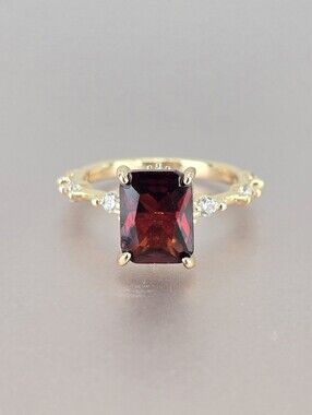 Gold Ring with Deep Red Radiant-Cut Gemstone and Accent Stones